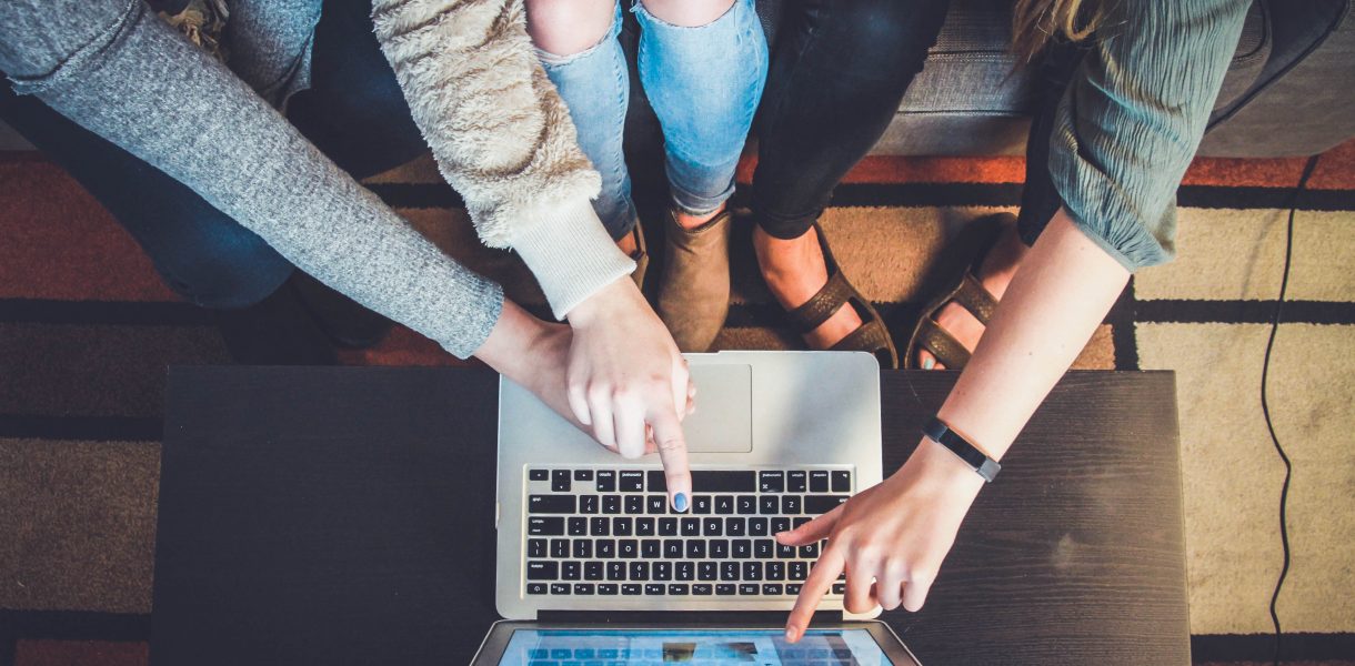 Professionals collaborating on a laptop